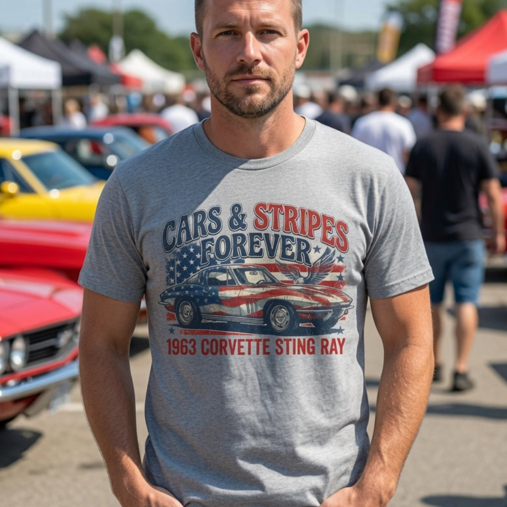 Man wearing a t-shirt with a Corvette Sting Ray graphic at a car show.